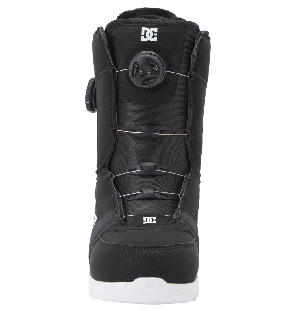 A front view of the Women’s Lotus BOA® Snowboard Boots by DC Shoes, in black with a white UNILITE outsole, featuring a Dual Zone BOA® Fit System and DC logos on the tongue and toe areas.