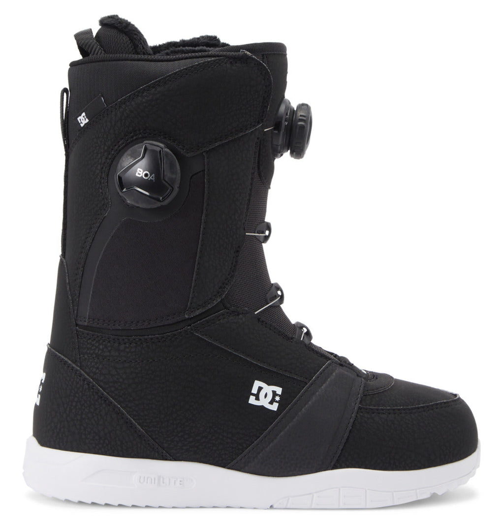 Introducing the Women’s Lotus BOA® Snowboard Boots by DC Shoes—featuring a sleek black design with a white UNILITE outsole, the iconic DC logo, and a Dual Zone BOA® Fit System for a customized fit.