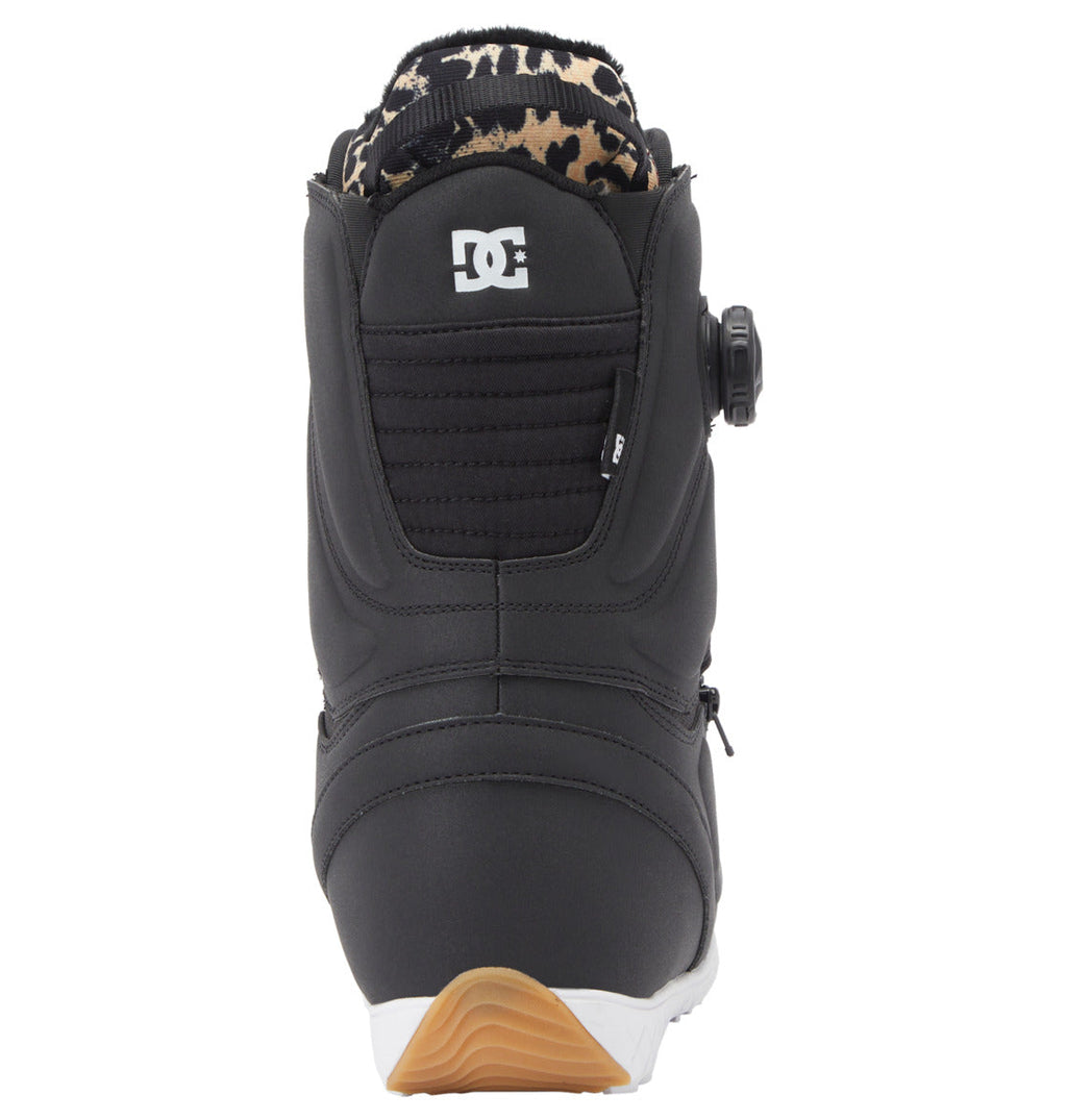 Women’s Mora BOA® Snowboard Boots by DC Shoes, shown from the back, display a white DC logo near the top, a textured black panel, a leopard-print inner lining, and a gum-and-white sole. Equipped with the advanced BOA® Fit System for personalized comfort and support.