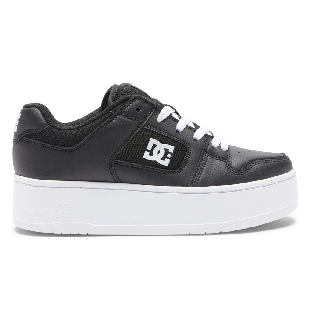 DC Shoes Women’s Manteca 4 Platform Shoes in black leather, showcasing a low-top silhouette with white laces, the classic white DC Shoes logo on the side, and a chunky white platform sole, presented in profile view.