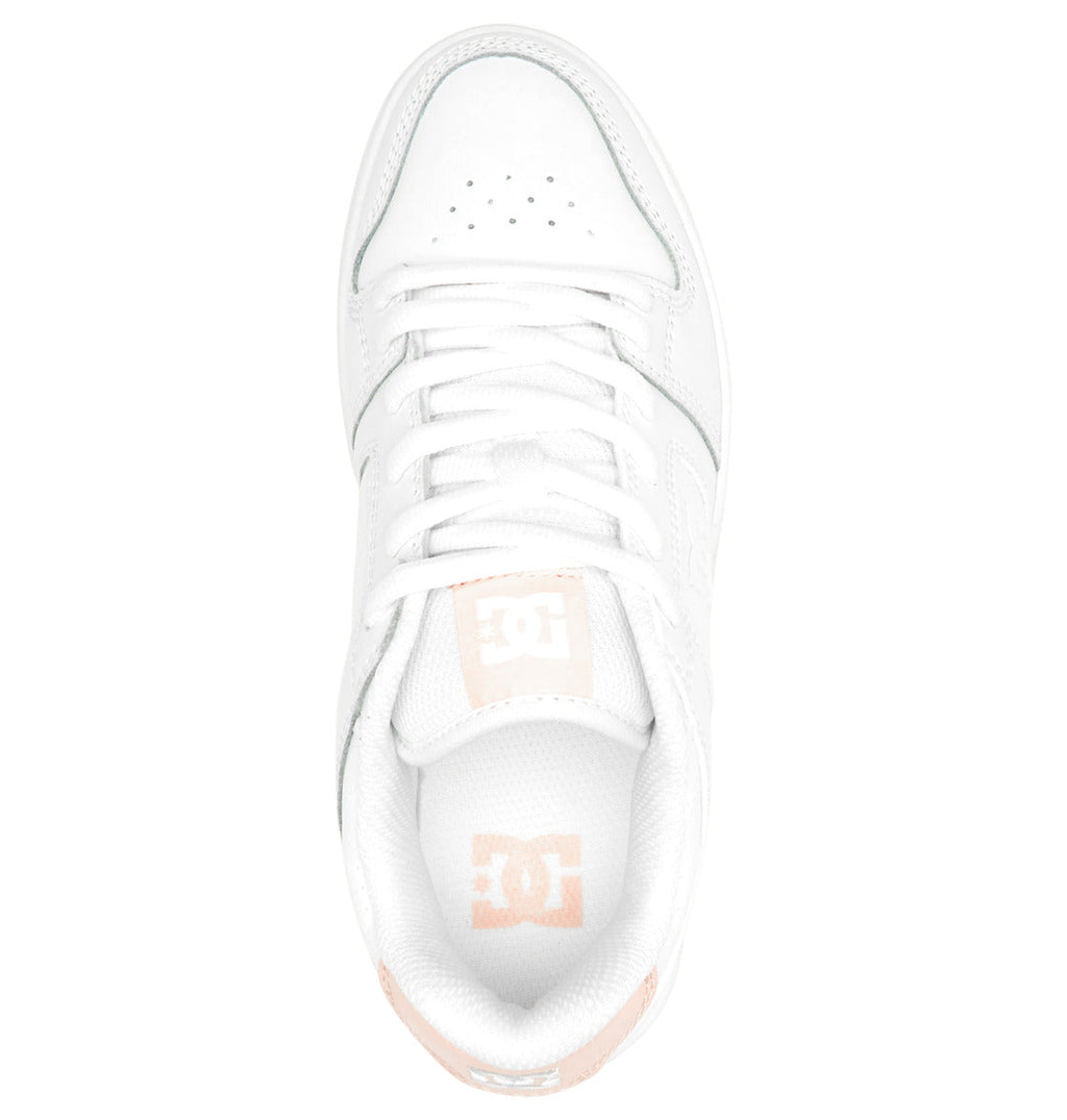 Top view of a white Women’s Manteca 4 Shoe from DC Shoes, featuring light pink accents, white laces, and perforations on the toe area; DC logo visible on the tongue and inside heel, highlighting its performance-focused design.
