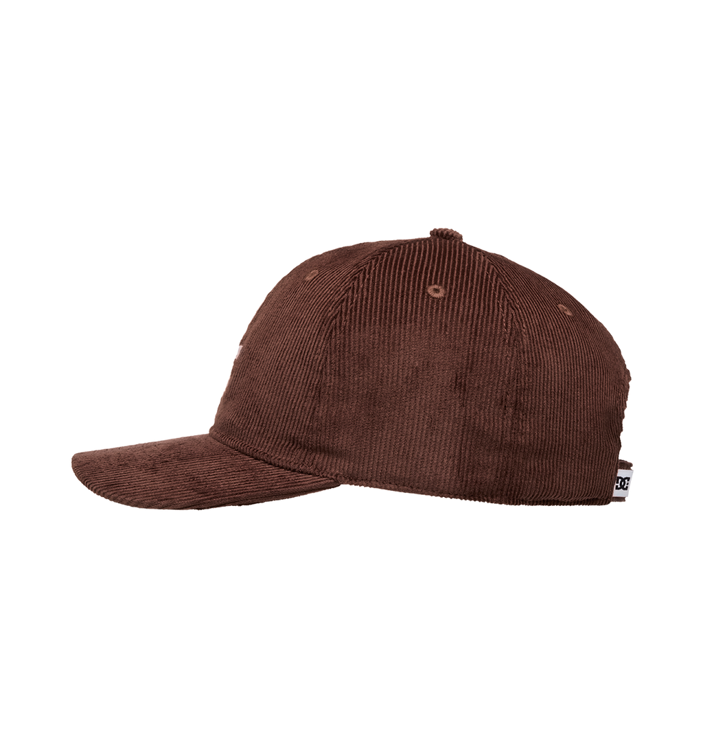 The Men's DC Cap Star Strapback by DC Shoes is displayed in side profile against a white background, showcasing its brown corduroy texture, curved brim, DC branding, and a small tag at the back.