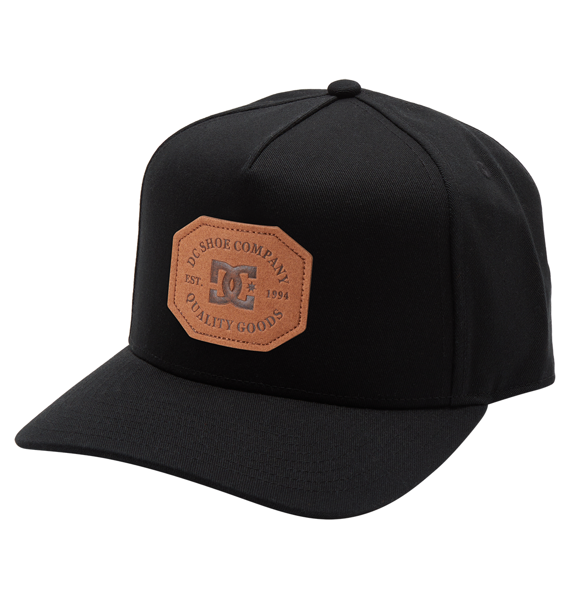 The Men's Reynotts Cap by DC Shoes is a black skate cap with a curved brim, featuring a brown leather front patch debossed with “DC Shoe Company, Est. 1994, Quality Goods.”.