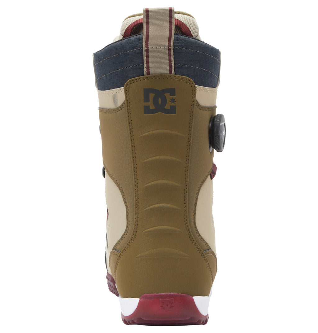 A rear view of the Men’s Premier Hybrid BOA® Snowboard Boots by DC Shoes, showcasing brown, beige, navy, and red panels, a black DC logo on the heel, and a textured red and white outsole equipped with the innovative BOA® Fit System for fast and precise adjustments.