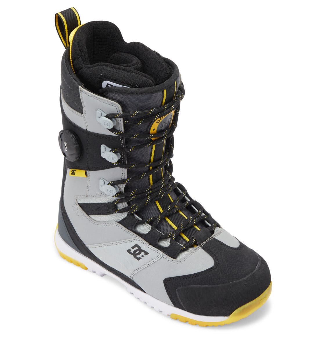 The Men’s Premier Hybrid BOA® Snowboard Boots by DC Shoes are shown at an angle in black, gray, and yellow with multiple laces, metal hooks, and the iconic DC Shoes logo on the side. Featuring the Premier Hybrid BOA® Fit System for optimal support and adjustability, these boots have a white sole with yellow tread.
