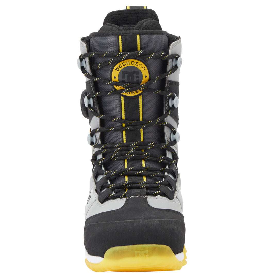 A front view of the Men’s Premier Hybrid BOA® Snowboard Boots by DC Shoes in black, gray, and yellow, featuring yellow-accented laces and a round DC SHOES logo near the top. The boots have a rugged design with Premier Hybrid construction for enhanced durability and are highlighted by a striking yellow sole.