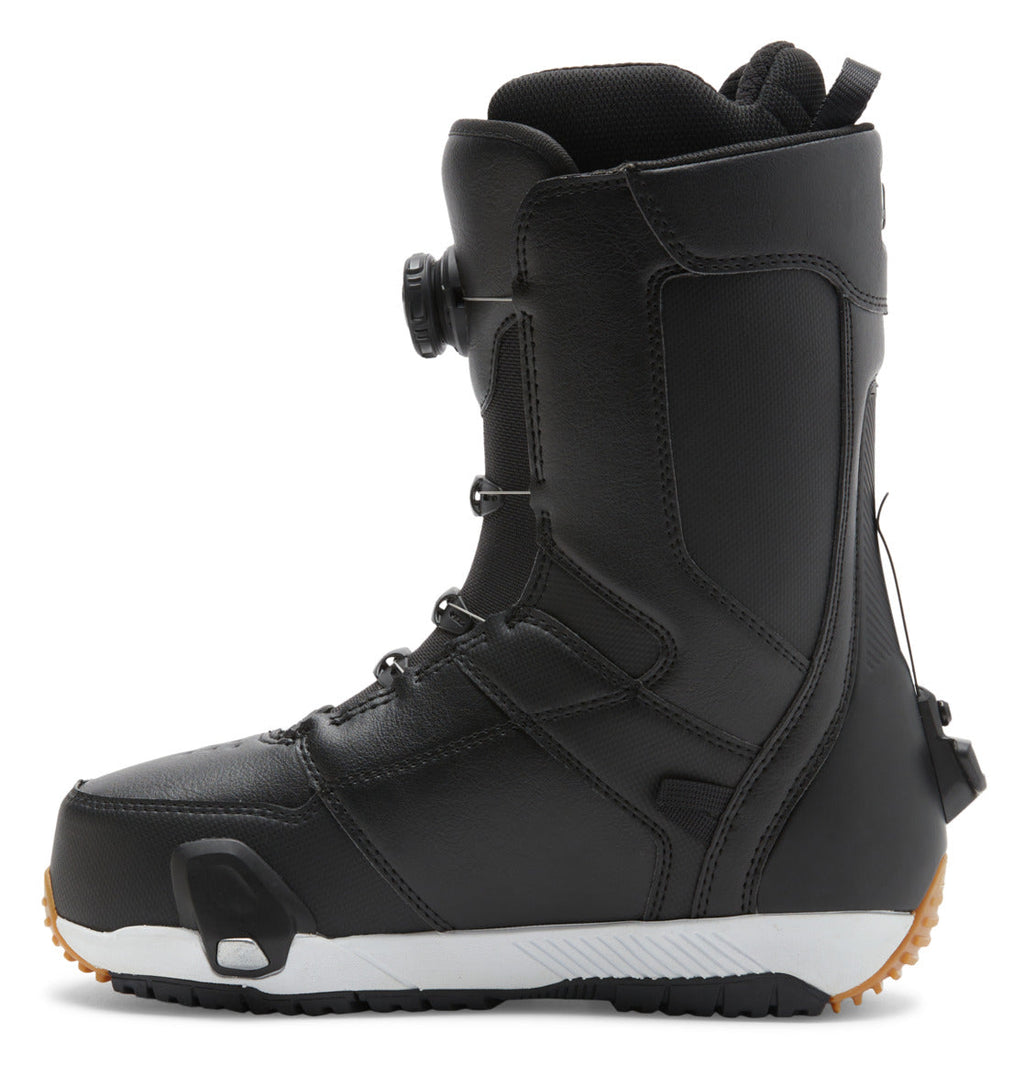 The DC Shoes Men’s Control Step On BOA® Snowboard Boots, shown in black with a textured sole, ankle support, and the Dual Zone BOA Fit System dial lacing system, are displayed from the side on a white background—highlighting true snow boot innovation.