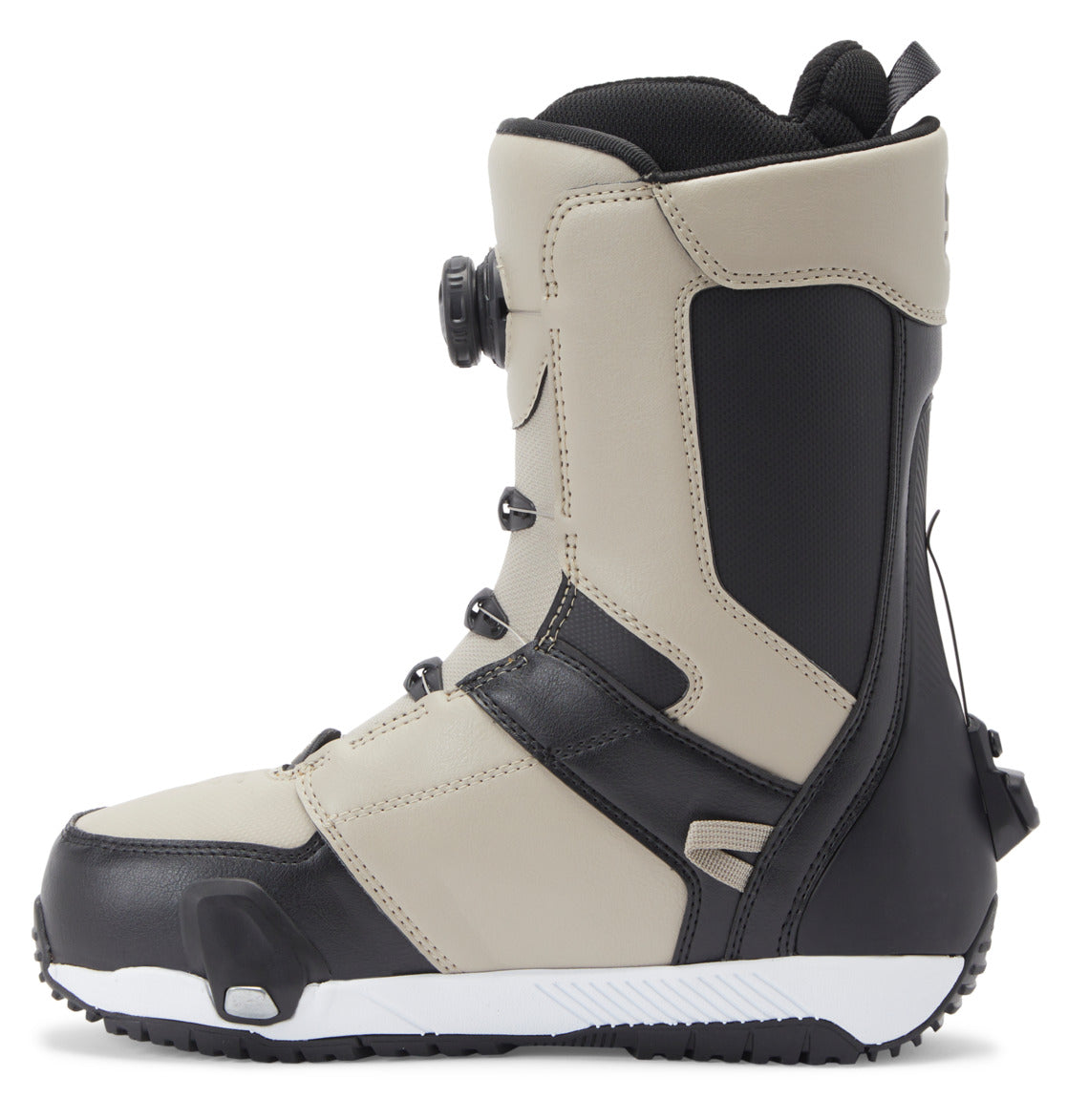 A side view of the DC Shoes Men’s Control Step On BOA® Snowboard Boots in beige and black, featuring a textured sole, Dual Zone BOA® Fit System dial closure, and reinforced panels against a white background—an impressive example of snow boot innovation.