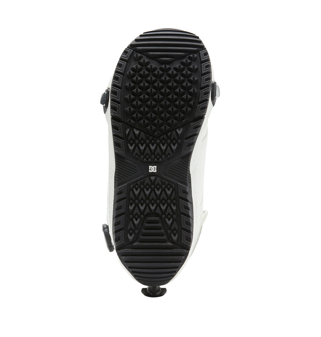 The image displays the black and white treaded sole of the DC Shoes Men’s Control Step On® Snowboard Boots, viewed from beneath, emphasizing its textured grip pattern—a testament to snow boot innovation.