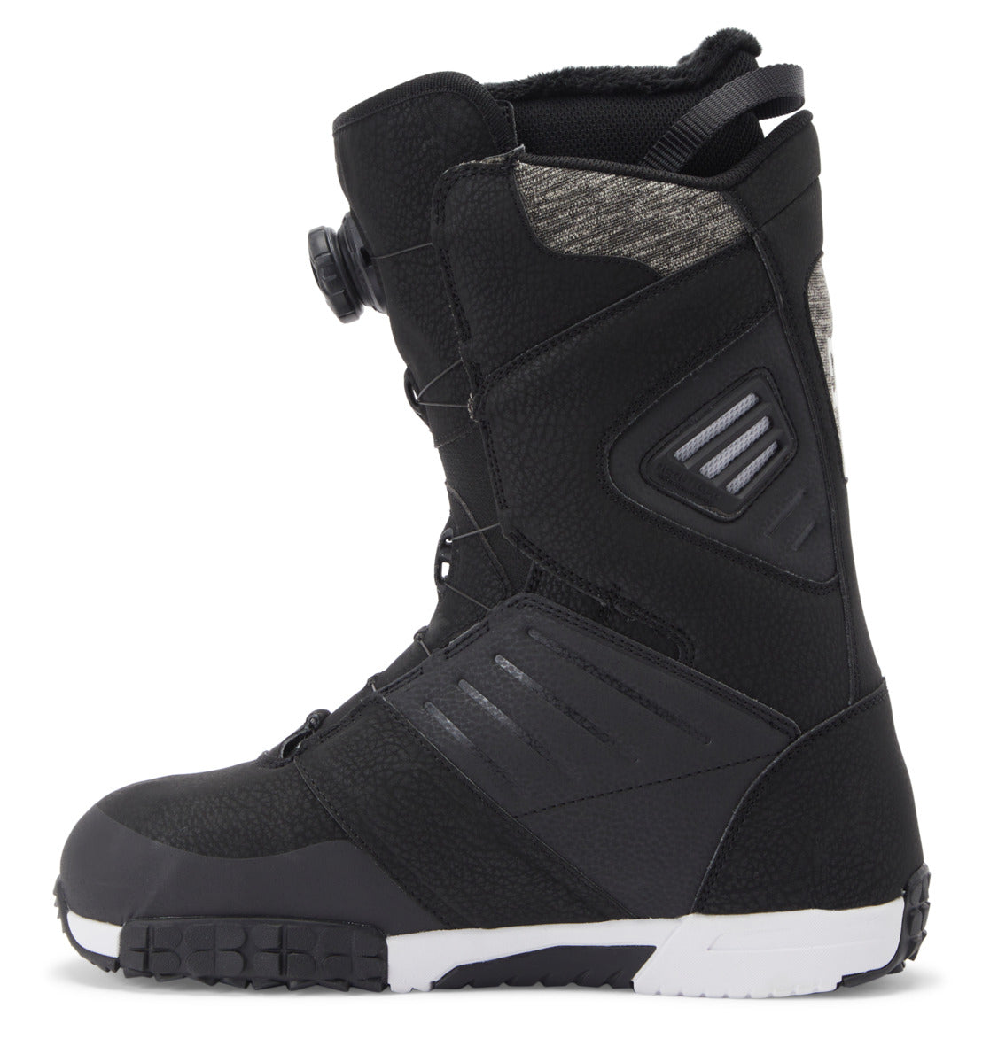 A left side profile of the DC Shoes Men’s Judge BOA® Snowboard Boot is shown on a white background, featuring black textured panels, a white and black Vibram outsole, and a Dual Zone BOA® Fit System dial closure.