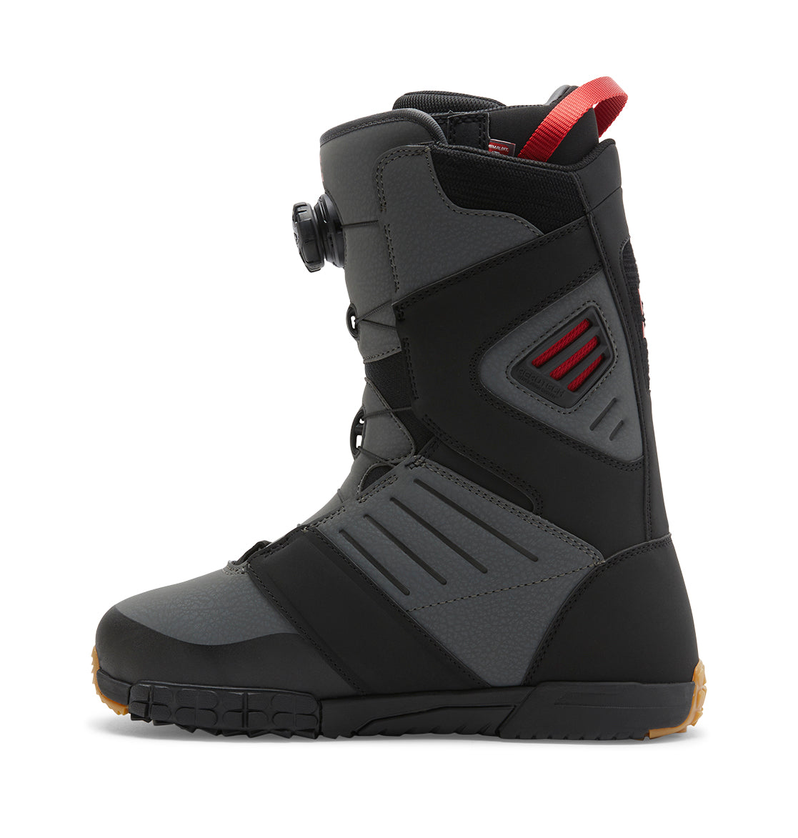 A profile view of the DC Shoes Men’s Judge BOA® Snowboard Boots in black and gray with red accents, featuring a textured rubber sole and a Dual Zone BOA® Fit System lacing mechanism, displayed against a white background.