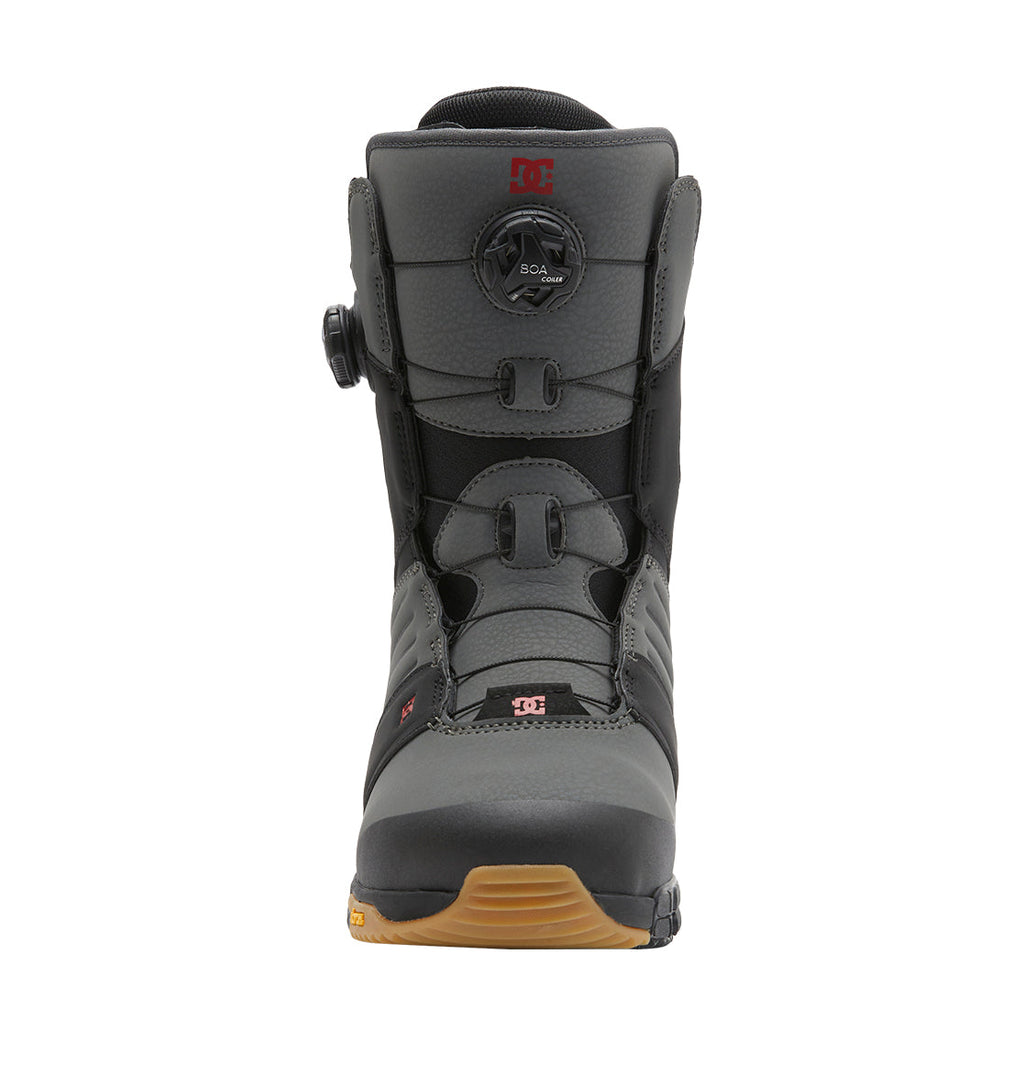 A front view of the DC Shoes Men’s Judge BOA® Snowboard Boots in gray and black, featuring a Dual Zone BOA® Fit System lacing system, red DC logo, and a brown rubber sole, set against a white background.