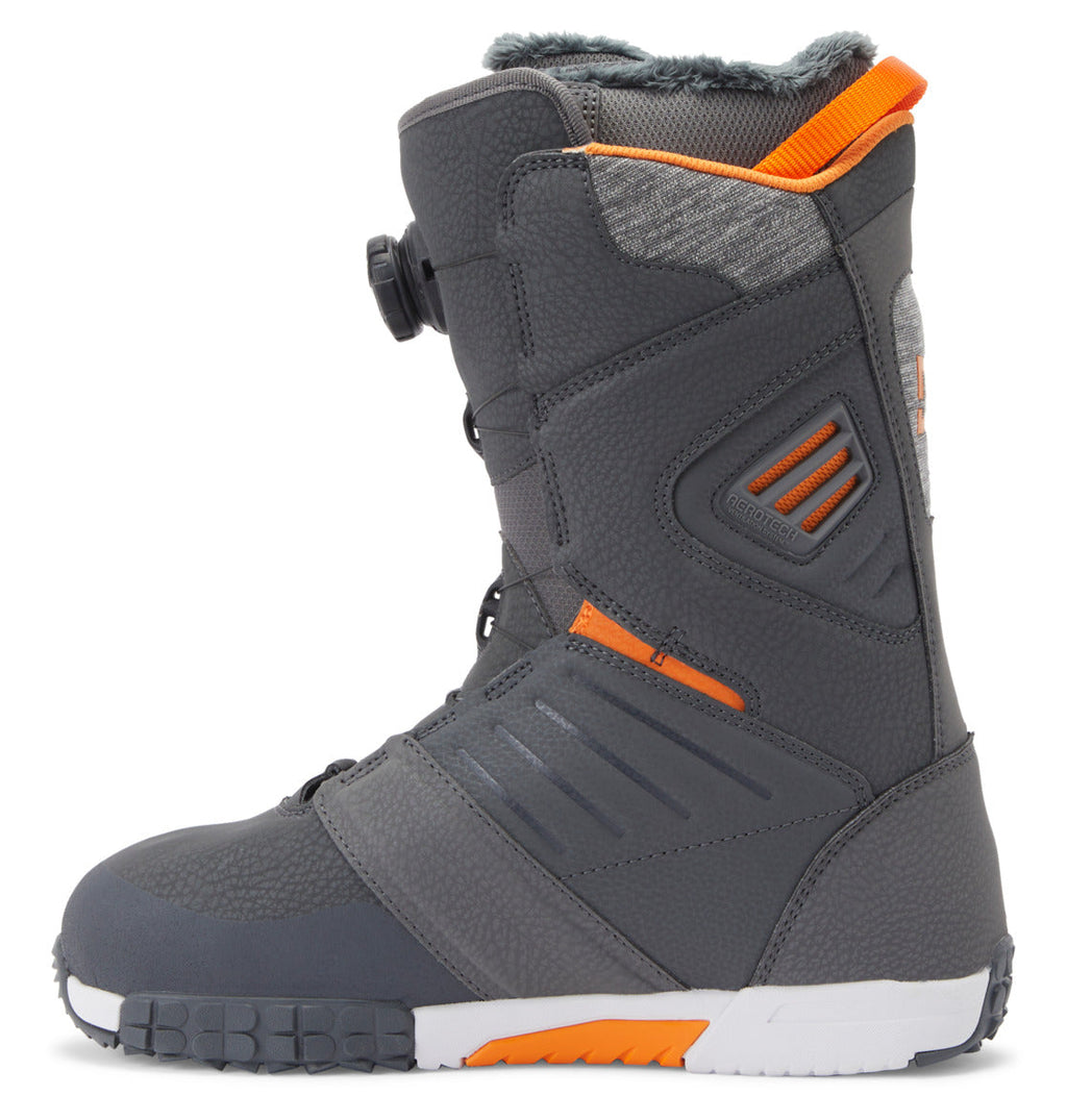 Introducing the DC Shoes Men’s Judge BOA® Snowboard Boots—a dark gray boot with orange accents, textured panels, and a rugged Vibram outsole for superior grip. The Judge Boot comes equipped with a Dual Zone BOA® Fit System for precise tightening on the side, and features a padded, insulated upper to keep your feet warm.