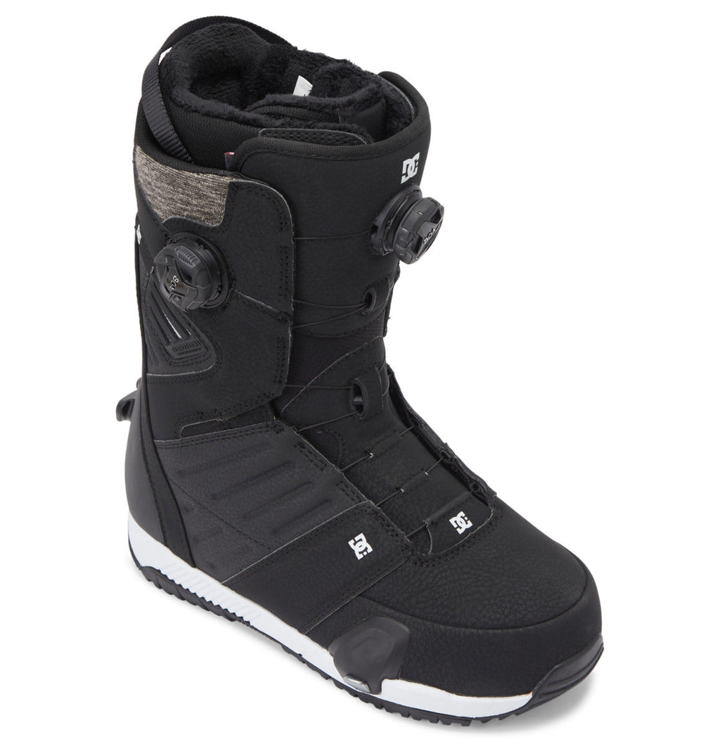 The Men’s Judge Step On® BOA® Snowboard Boots from DC Shoes feature a high-ankle black design with dual BOA® Fit System dials for precise tightening, textured panels, and DC branding on the side and foot. The boots have a white sole with a contrasting black tread pattern.