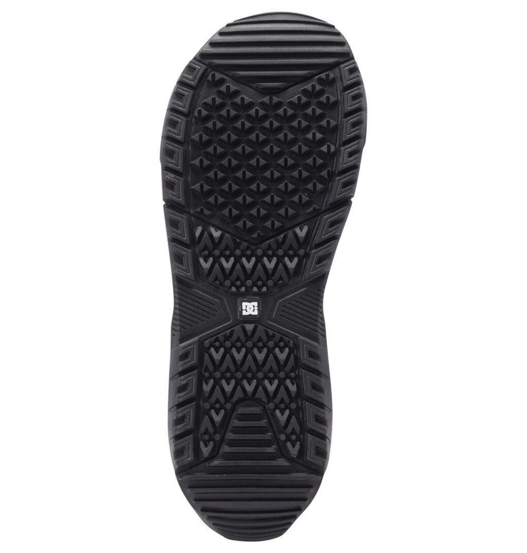 Black outsole of the Men’s Judge Step On® BOA® Snowboard Boots by DC Shoes, shown from below with an array of textured patterns—triangles and lines—and a small DC Shoes logo at the center; this grip-focused design draws inspiration from the proven traction of Step On boot technology and advanced snowboard boot innovation.