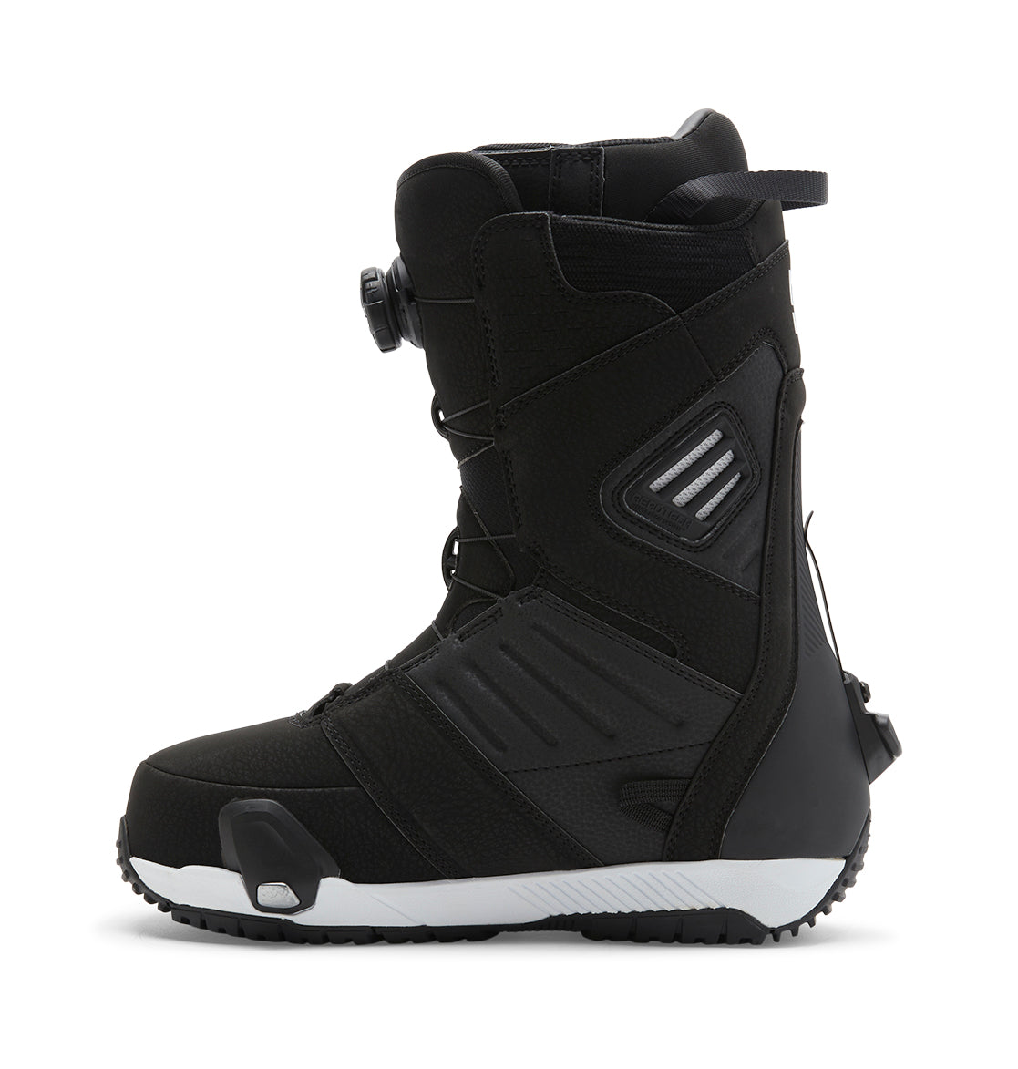 The DC Shoes Men’s Judge Step On® Snowboard Boot features a black, textured exterior with reinforced panels, a white sole, and black tread. It is equipped with a Dual Zone BOA Fit System for customizable tightening and includes a pull loop at the back. The boot is displayed in side profile on a white background.