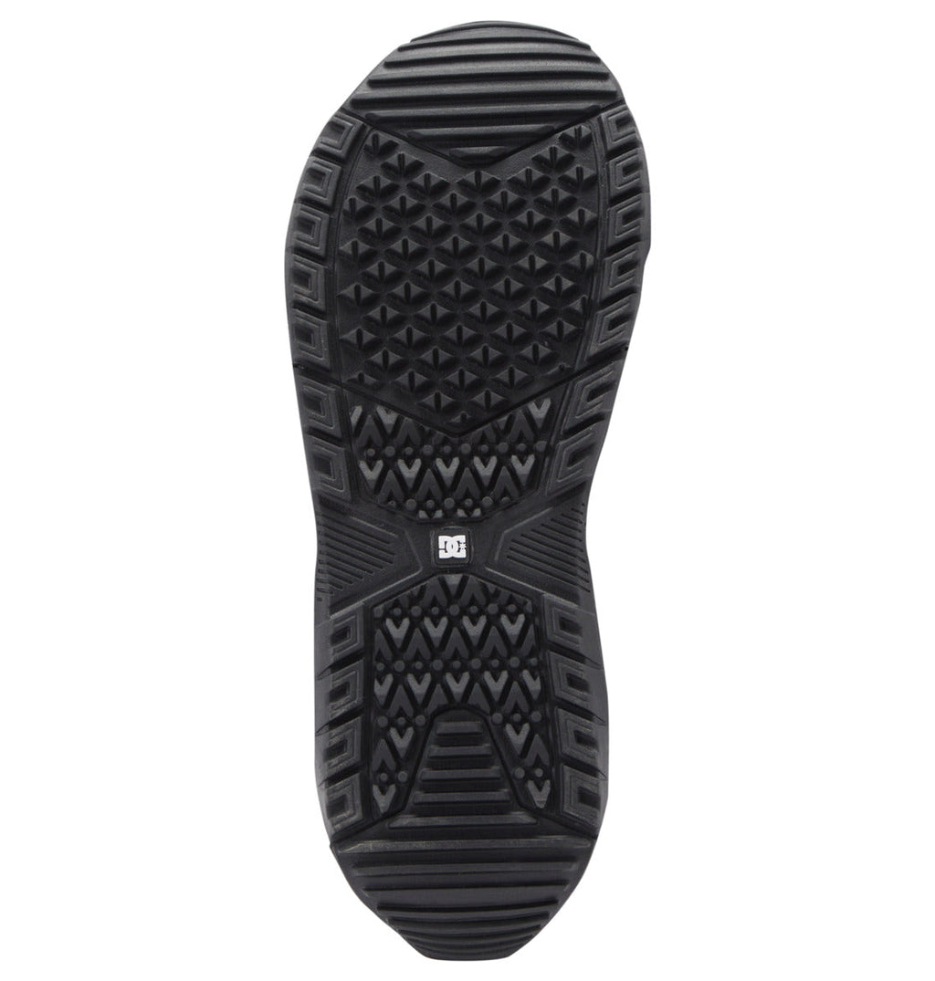 A black rubber outsole featuring various geometric tread patterns—such as triangles and lines—for optimal traction, designed specifically for DC Shoes Men’s Judge Step On BOA® Snowboard Boots. A small logo near the center of the sole indicates its compatibility with Step On systems.