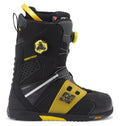 The Men’s Phantom BOA® Snowboard Boots by DC Shoes are shown in a side profile on a white background, featuring a black and yellow design with the BOA® Fit System for easy adjustment, DC branding, PrimaLoft insulation for added warmth, and a Vibram sole.