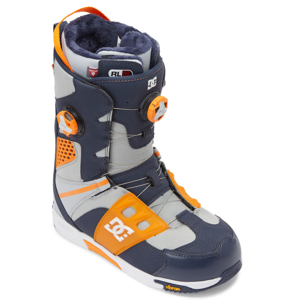 A single DC Shoes Men’s Phantom BOA® Snowboard Boot in navy blue, orange, and gray is displayed at a slight angle on a white background, featuring the DC logo, dual BOA Fit System dials for precise adjustment, and a Vibram sole with PrimaLoft insulation for enhanced warmth.
