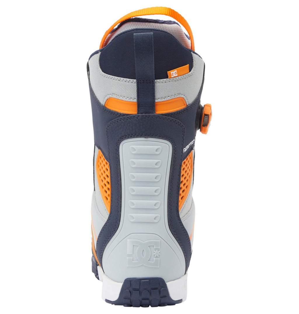 Rear view of the DC Shoes Men’s Phantom BOA® Snowboard Boots, showcasing navy, orange, and gray colors with a textured sole, a pull loop at the top, PrimaLoft insulation for added warmth, and the DC Shoes logo embossed on the heel.
