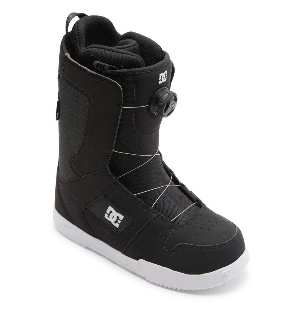 The Men’s Phase BOA® Snowboard Boots by DC Shoes are black with a white sole, feature the DC logo and advanced BOA Fit System dial lacing, and include IMPACT-ALG insoles for enhanced comfort; displayed at an angle on a white background.