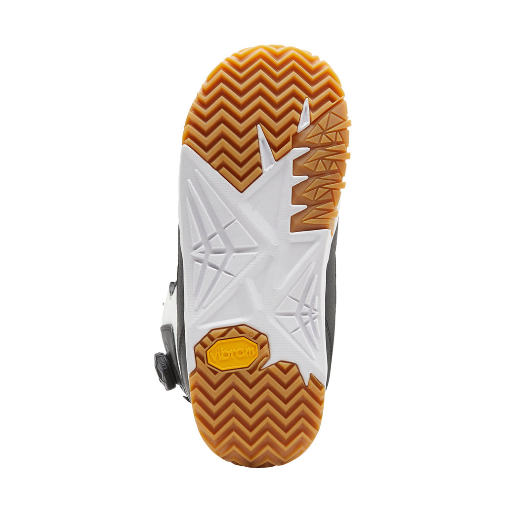 The sole of the Men’s Transcend BOA® Snowboard Boots by DC Shoes, featuring a white geometric pattern, brown zigzag tread, and a yellow Vibram logo near the heel, viewed from the bottom.