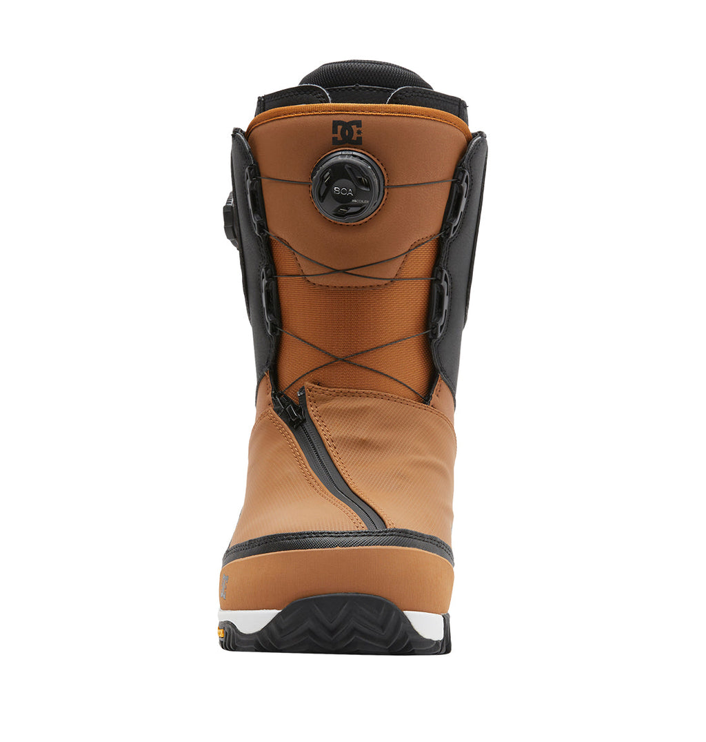 The Men’s Transcend BOA® Snowboard Boots by DC Shoes, shown in brown and black with a front zipper and a circular BOA® Fit System dial tightening system, are displayed from the front against a white background.