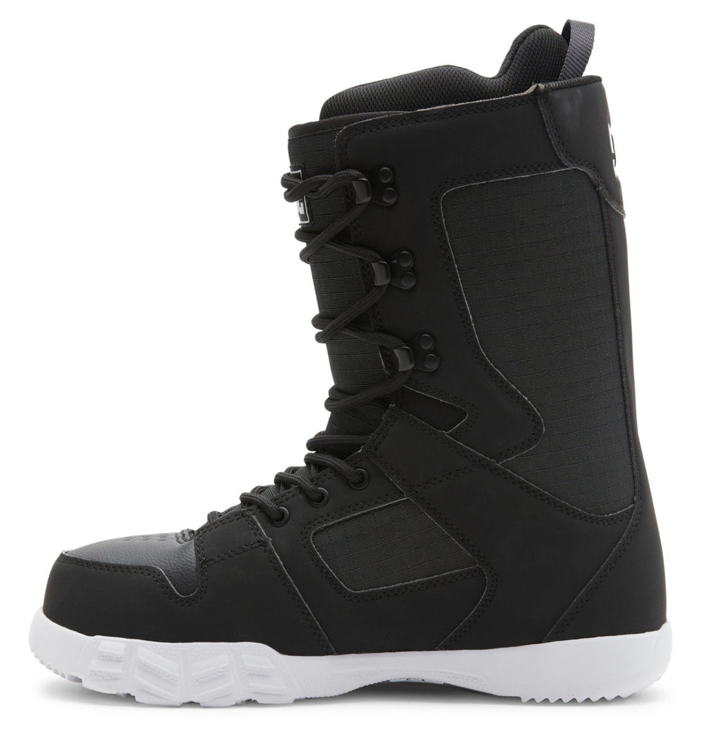 The DC Shoes Men’s Phase Lace Snowboard Boots are shown in a side view, featuring a black upper with a contrasting white sole. These boots offer medium flex for balanced support, utilize black laces with traditional lace closure through metal eyelets, and include reinforced stitching along with a pull tab on the heel. The design is modern and sturdy.