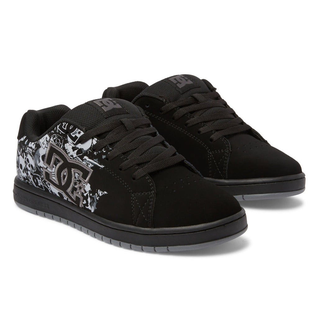 Step up your skate and street style with the Men’s Gaveler Shoes from DC Shoes. These black sneakers feature thick soles, durable leather construction, and black laces, highlighted by graffiti-style DC branding and bold white graphic designs on the sides. Combining rugged durability with a chunky silhouette, they’re ideal for both skating sessions and everyday wear.