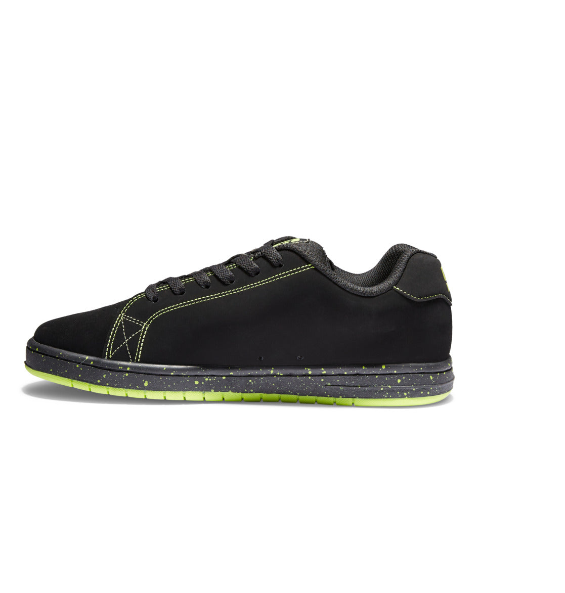 A side-view image of the Men’s Gaveler Shoes by DC Shoes shows a black chunky sneaker crafted from durable leather, featuring green speckled soles, green stitching, and black laces, displayed against a white background.