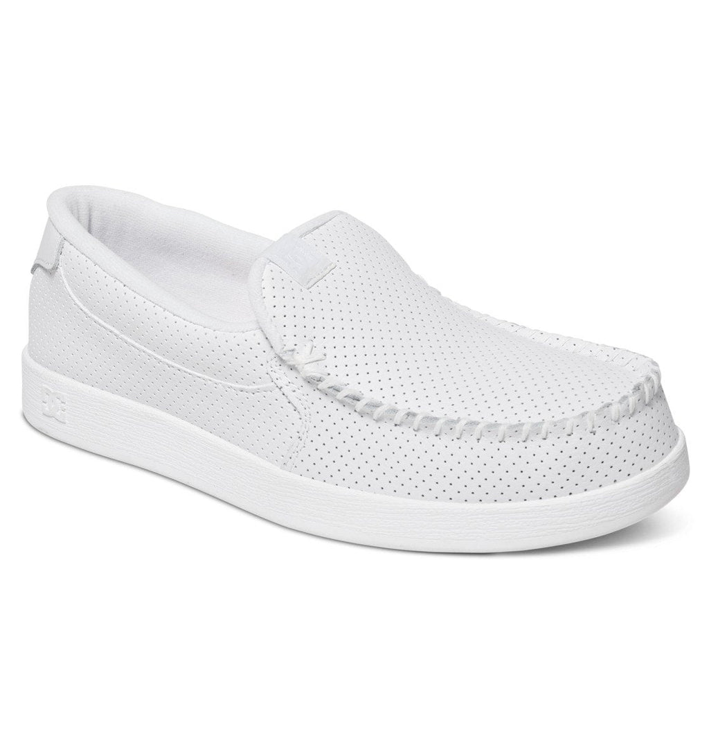 The Men’s Villain Slip-On Shoes by DC Shoes feature a lightweight white design with perforated detailing, visible stitching around the toe, and a flat sole—making them a comfortable and stylish choice for casual everyday wear.