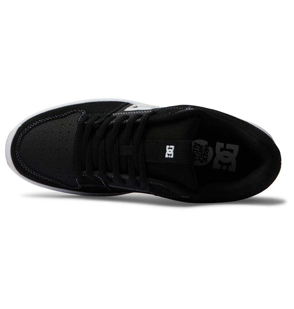 Top view of the Men’s Lynx Zero Shoes by DC Shoes in black with white accents, featuring black laces, a perforated toe, and the signature white DC logo on the insole—ideal for fans of classic skate shoe style.