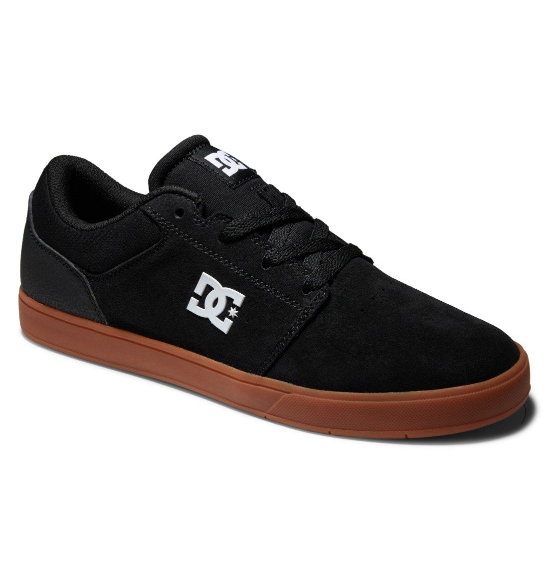 The Men’s Crisis 2 Shoes from DC Shoes feature a sleek black design with matching black laces, a white DC logo on the side, and a durable brown rubber sole. Viewed from a slight angle, these affordable skate shoes offer classic style and everyday comfort perfect for skaters.