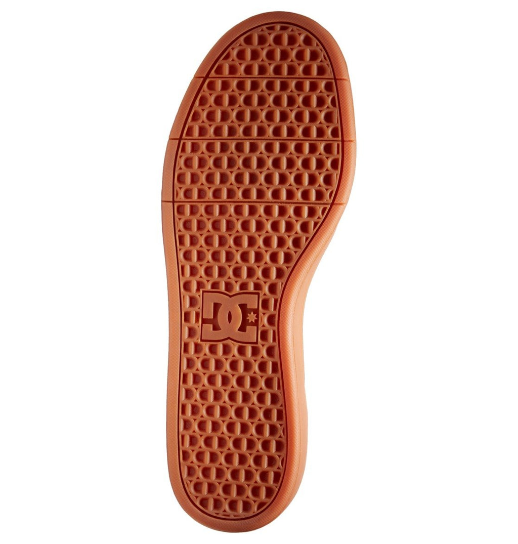The Men’s Crisis 2 Shoes by DC Shoes feature an orange sole with a geometric tread pattern and the DC Shoes logo embossed near the heel.