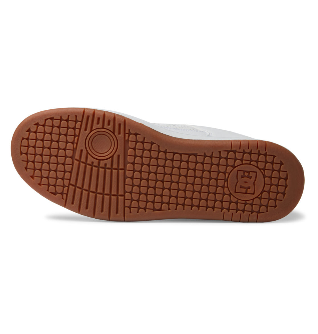 The gum sole of the DC Shoes Men’s Manteca 4 features a textured tread pattern with a circular design near the toe and a raised DC logo near the heel.