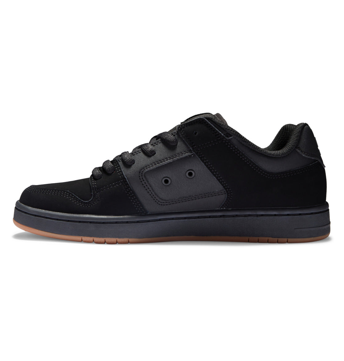 The DC Shoes Men’s Manteca 4 Shoes are black low-top skate shoes featuring black laces, a matching black sole, subtle stitching details, and a brown rubber outsole. Shown in a side profile against a white background, they deliver modern comfort and style.