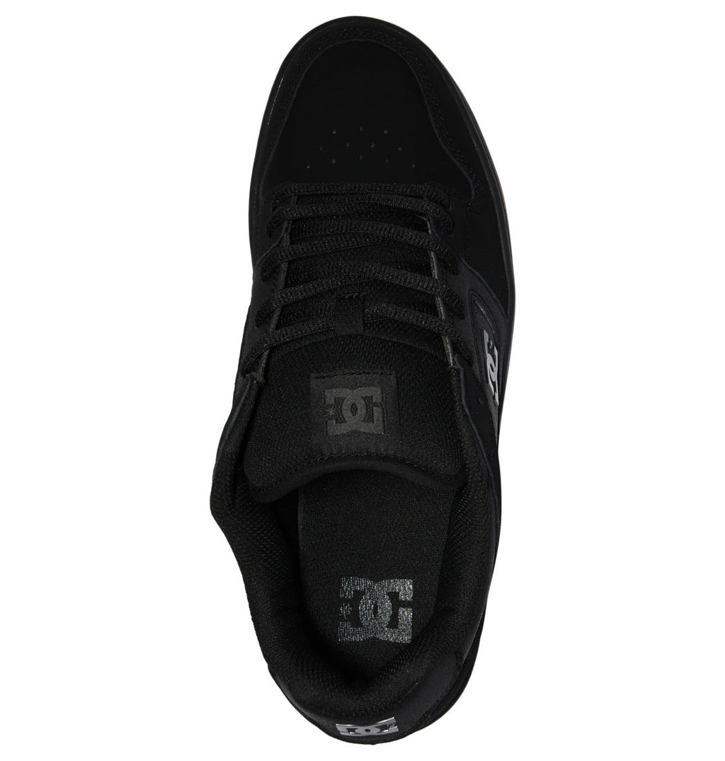Top view of the DC Shoes Men’s Manteca 4 skate shoe in black, featuring black laces, breathable perforations on the toe area, and the DC logo displayed on both the tongue and insole—delivering modern comfort with every step.