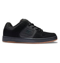 A pair of Men’s Manteca 4 Shoes by DC Shoes, featuring a black upper with a dark gray sole and gum accents, the signature DC logo on the side, and a padded tongue and collar for modern comfort.