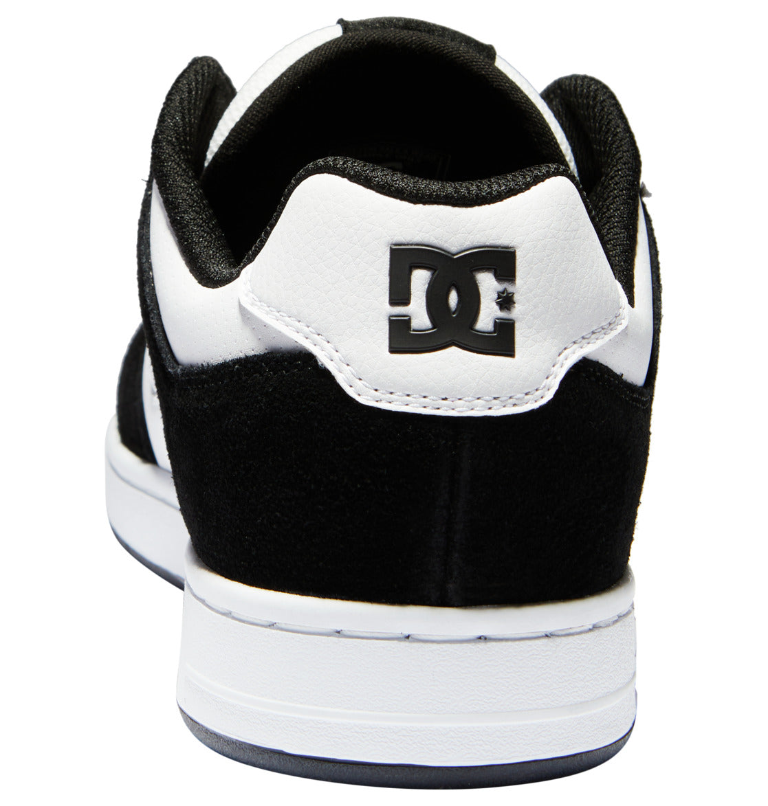 The Men’s Manteca 4 Shoes by DC Shoes are black and white skate shoes seen from the back, displaying the iconic DC Shoes logo on the heel. This model features a white midsole paired with a black outsole, combining classic style with modern comfort.