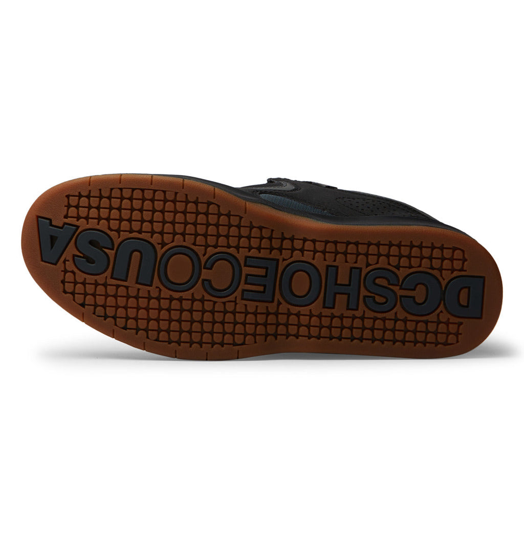 The sole of the DC Shoes Men’s Kalynx Zero Shoes features a black base with a brown tread and prominently displays the bold DCSHOESCOUSA text across the bottom—a signature detail characteristic of this style.