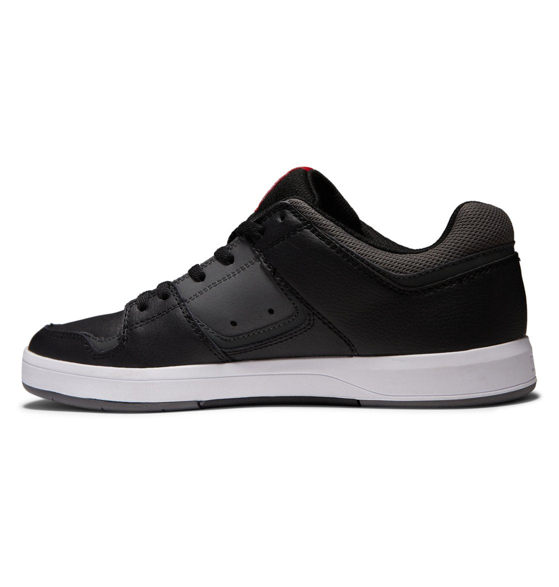 A side view of the Men’s DC Cure Shoes by DC Shoes: black low-top sneakers with matching black laces, a light gray sole, and a padded ankle collar crafted from premium leather nubuck, displayed against a white background—ideal for everyday wear or enthusiasts of the signature DC Shoes style.