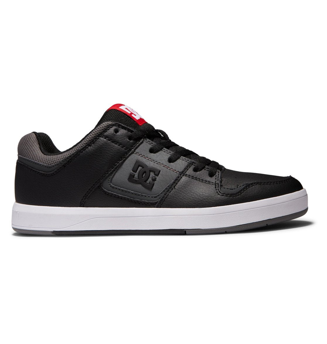 The Men’s DC Cure Shoes by DC Shoes feature a black leather and nubuck upper, a white sole, gray detailing at the heel, and red branding on the tongue. Durable and stylish for everyday wear, this shoe is shown in a side view against a white background.