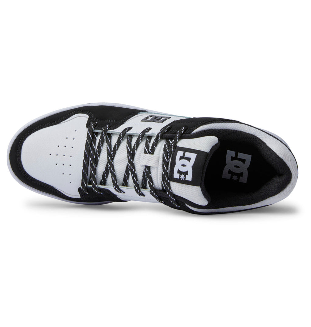 Top view of the Men’s DC Cure Shoes by DC Shoes in black and white, with matching laces, DC logos on the tongue and side, a durable leather upper, and perforated detailing on the white toe—ideal for everyday wear.