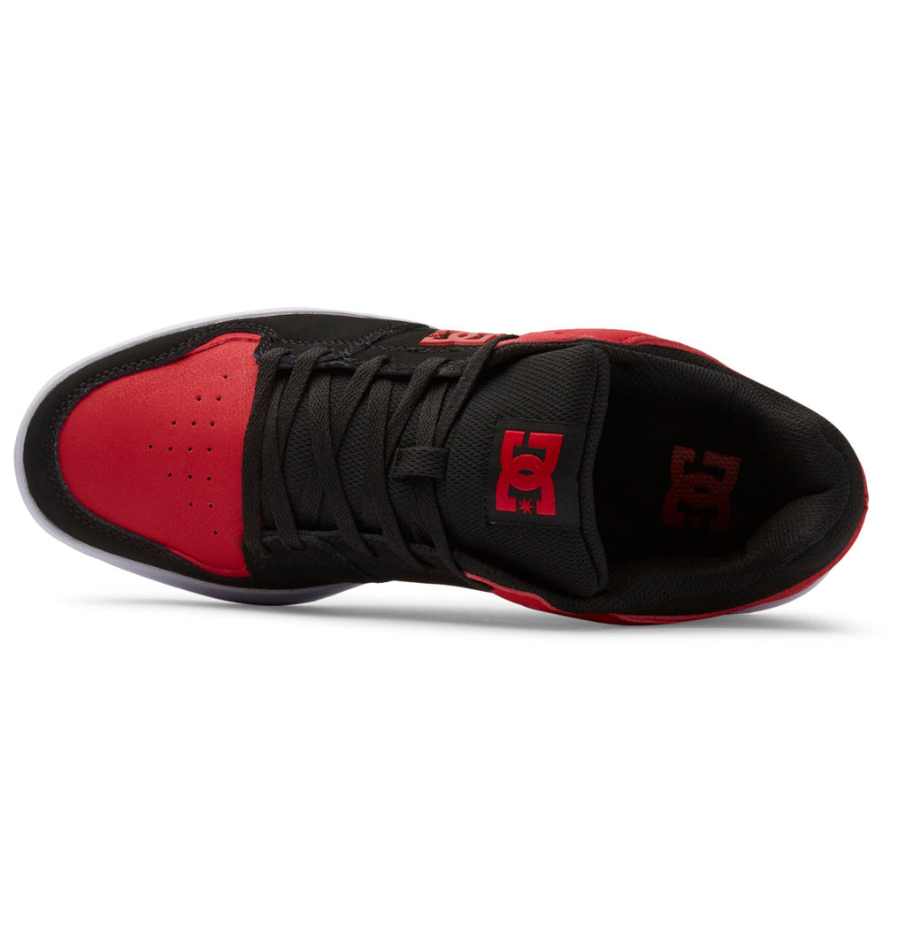 Top view of a Men’s DC Cure Shoe by DC Shoes in black and red, featuring black laces, a red toe cap, and a red DC logo on the tongue. This low-cut sneaker boasts a layered leather upper, making it an ideal choice for stylish everyday wear.