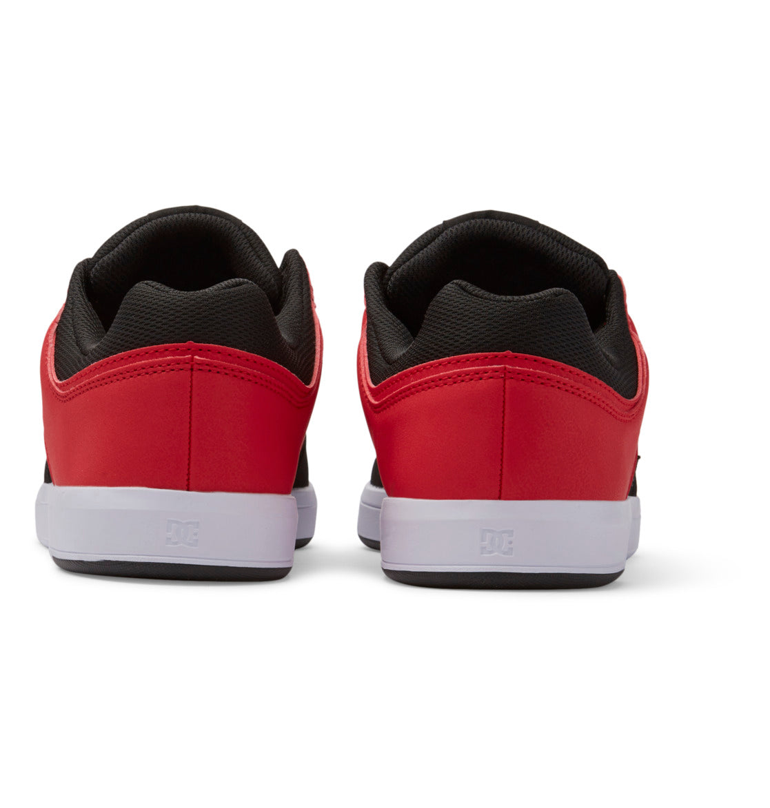 A pair of Men’s DC Cure Shoes by DC Shoes, in a stylish red and black colorway with a leather upper, are shown from the back. They feature crisp white soles and are set against a white background—making them an ideal choice for everyday wear.
