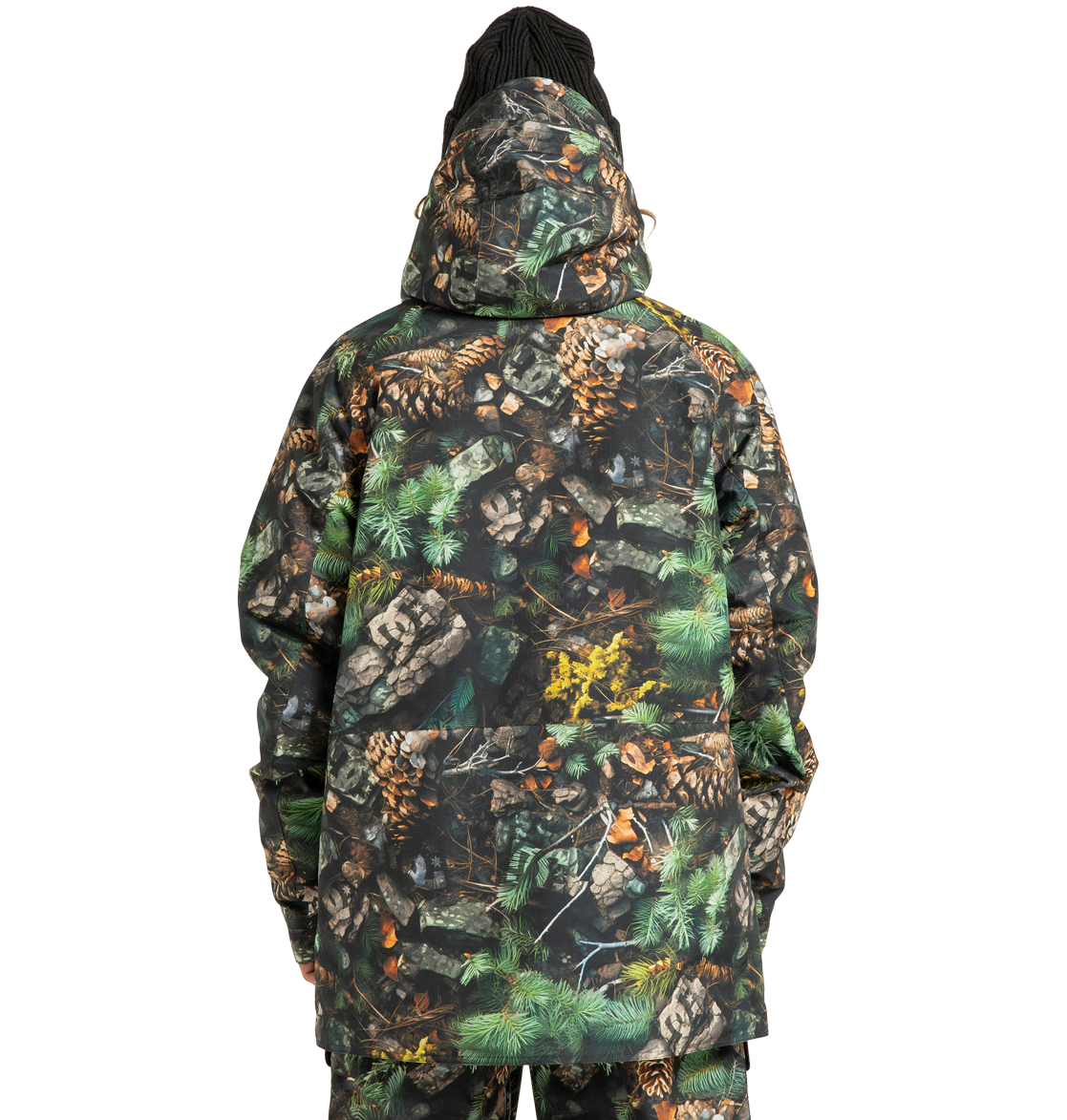 A person wearing the DC Shoes Men’s Tundra Insulated Jacket, featuring an eco-friendly design with a forest camouflage pattern of pinecones, leaves, and green foliage, stands facing away from the camera against a plain white background.
