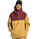 A person wearing a mustard yellow and maroon Men’s DC-43 Anorak Shell Jacket by DC Shoes, featuring a front pocket, tan pants, a black beanie, and ski goggles on their head stands with hands in pockets against a plain white background. This stylish jacket is made from recycled polyester and functions as a versatile weather defense shell, providing comfort and protection in any condition.
