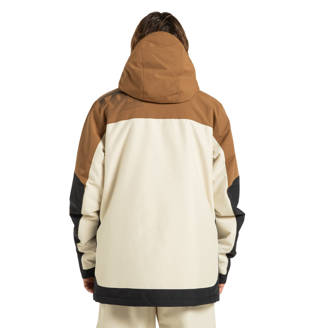 A person is seen from behind, wearing the Men’s Defiant Insulated Snow Jacket Jacket by DC Shoes, which features bold color blocking in brown, cream, and black. The winter jacket has long sleeves and a relaxed fit for easy layering. The hood is pulled up over their head and hair, delivering extra warmth for cold days.