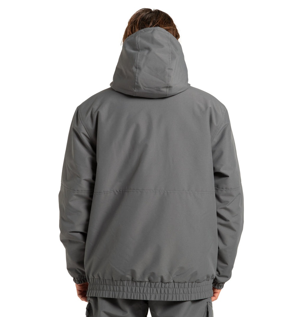 A person is shown from the back, facing away from the camera, wearing the DC Shoes Unisex Nexus Reversible Insulated Anorak Jacket in gray with the hood up and hands at their sides.