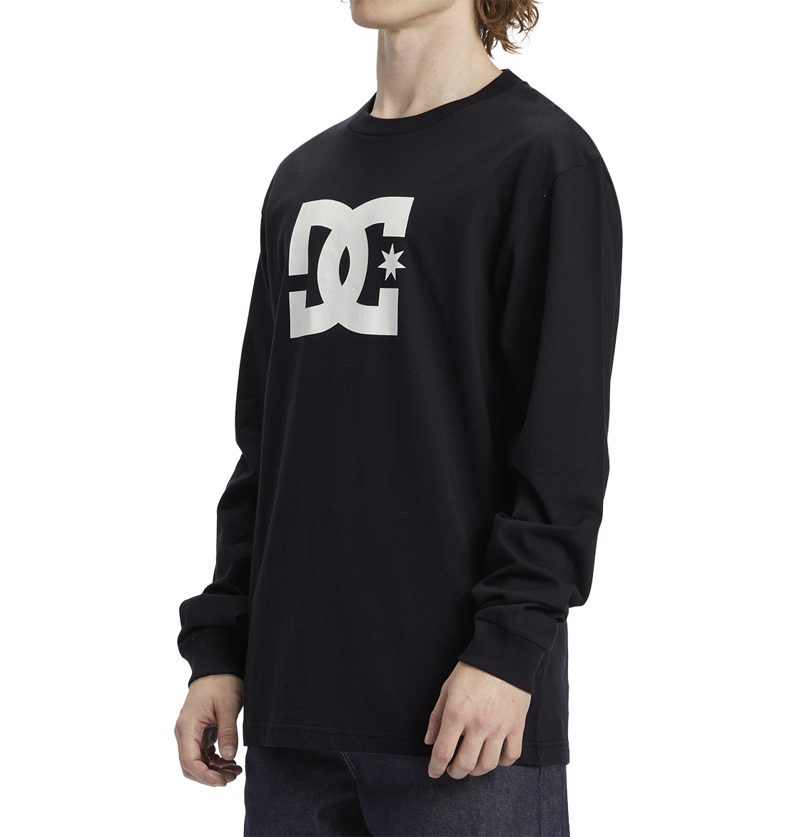 A man models the Men's DC Star Tee by DC Shoes—a black long-sleeve shirt with the white DC Shoes logo on the chest—against a plain white background.